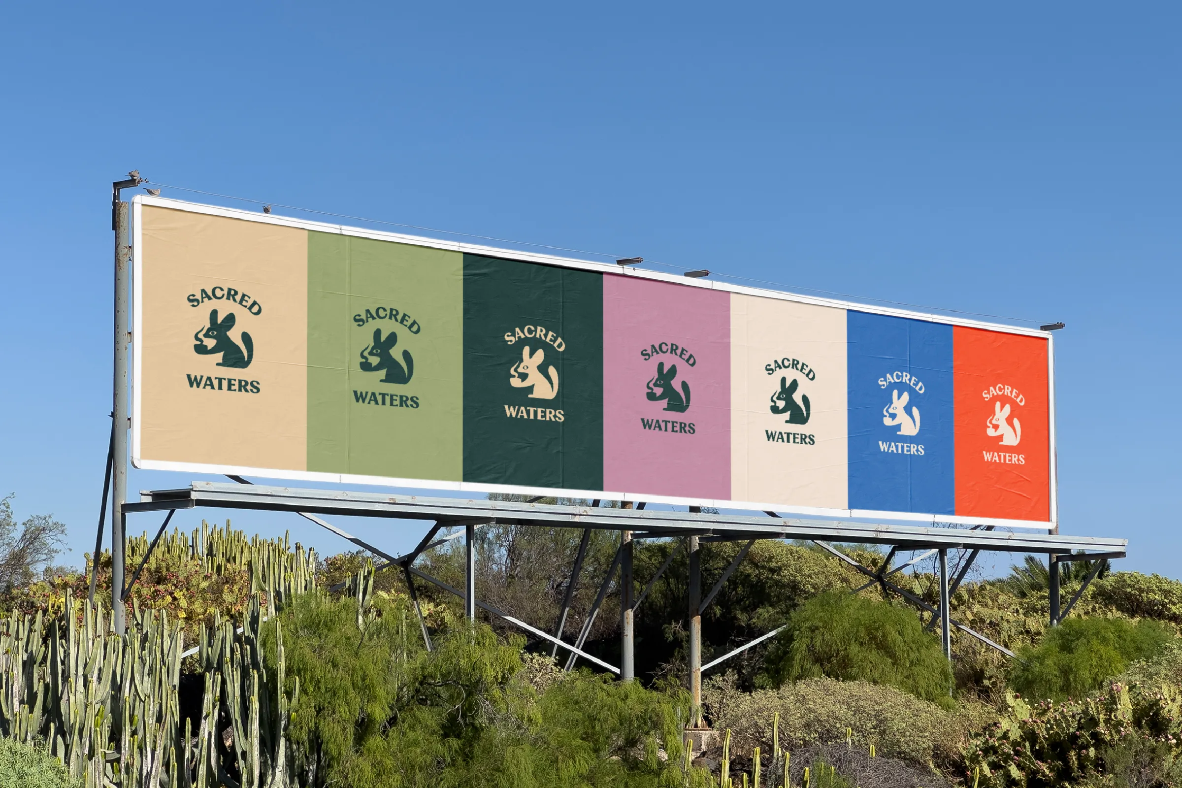 Billboard in a desert landscape with the Sacred Waters logo repeated across seven brand colors