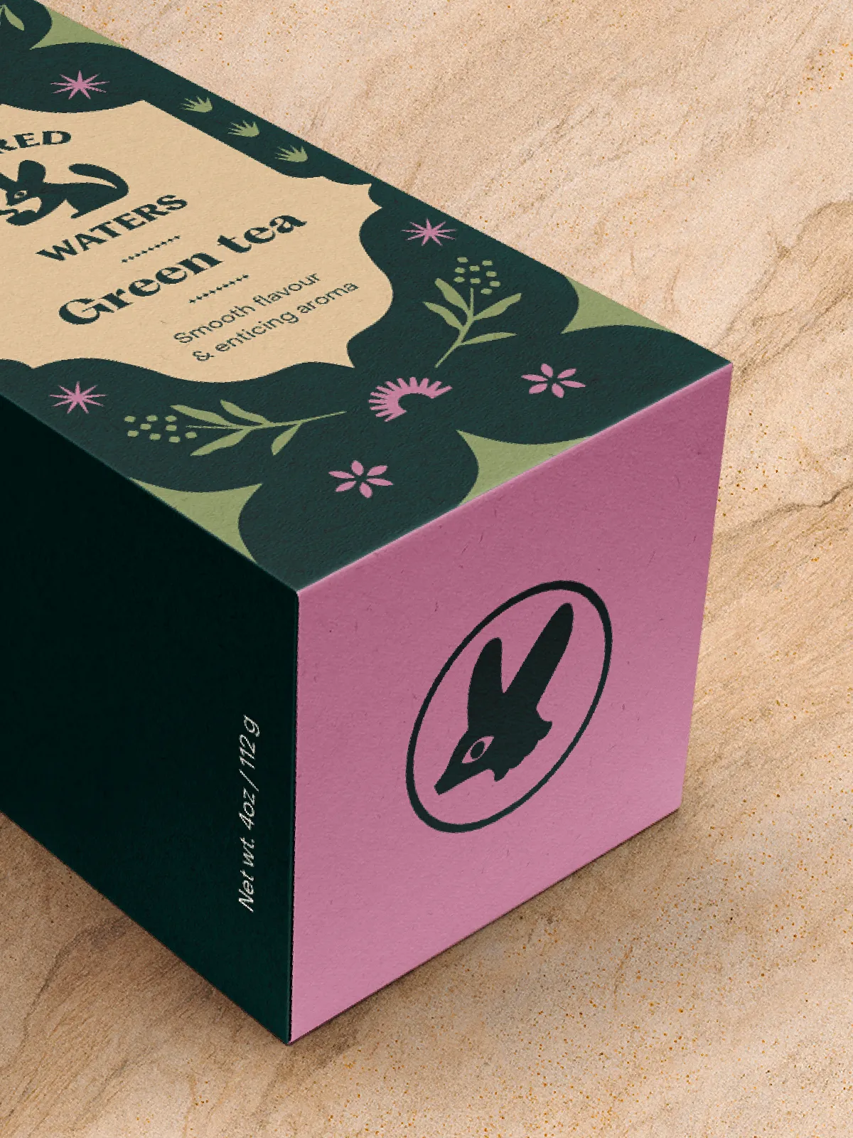 Green tea box seen from above, with a pink side panel showing the fennec fox emblem